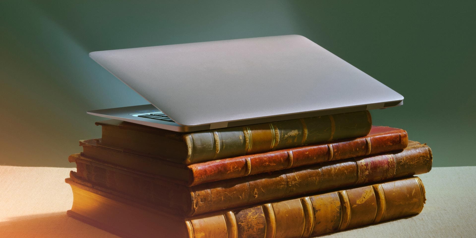 The image features a stack of books, showcasing their bindings. It is set indoors, emphasising the stationary nature of the arrangement. The collection highlights various book genres or subjects without any specific focus on a single title.